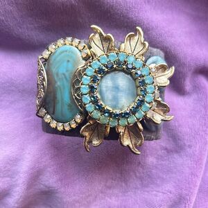Pretty jewel encrusted cuff with cloth wrapping.